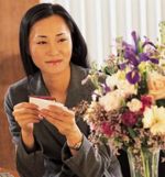 Asian woman with flowers and card sm.jpg