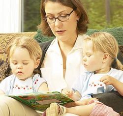 Two small children with woman reading sm.jpg